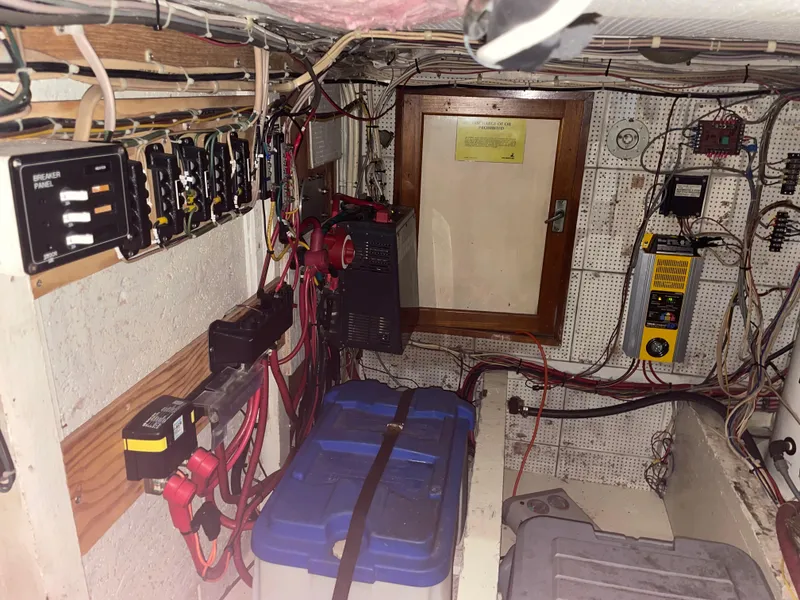 Slide: The Image of Electrical system inside a 1964 Grand Banks 42 Classic boat, featuring wiring and breaker panels. - 67