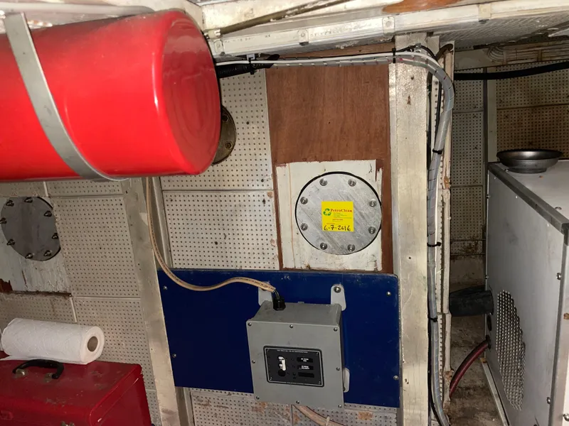 Slide: The Image of Engine room of a 1964 Grand Banks 42 Classic boat with equipment and wiring. - 68