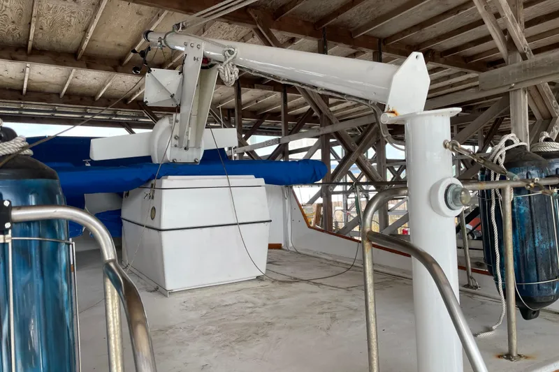 Slide: The Image of 1964 Grand Banks 42 Classic yacht deck with crane and blue cover. - 9