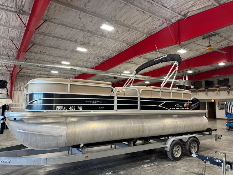 The Image of 2018 Sun Tracker Party Barge 22 DLX pontoon boat on trailer in indoor storage. - 1