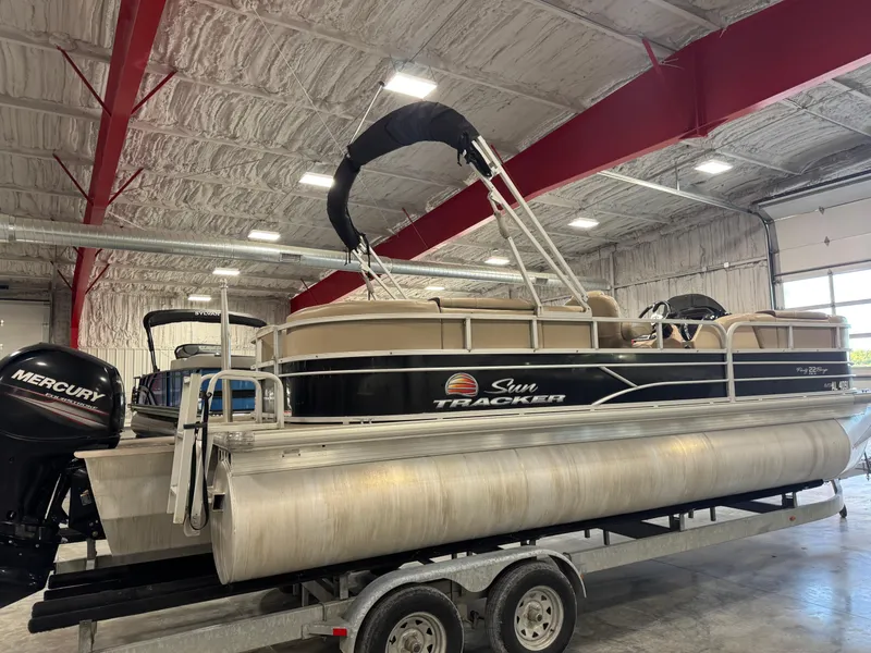 Slide: The Image of 2018 Sun Tracker Party Barge 22 DLX pontoon boat on trailer in indoor storage. - 3