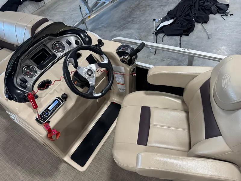 Slide: The Image of 2018 Sun Tracker Party Barge 22 DLX helm with beige seating and control panel. - 8