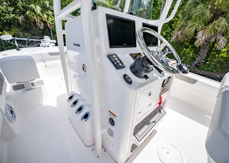 Slide: The Image of 2024 Caymas 26 HB boat helm with steering wheel and control panel. - 18