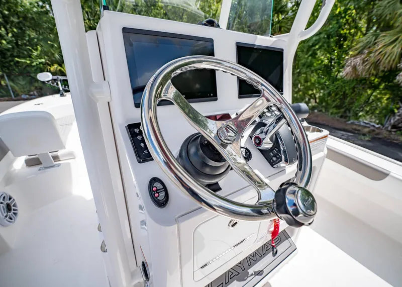 Slide: The Image of 2024 Caymas 26 HB boat dashboard with steering wheel and electronic displays. - 19