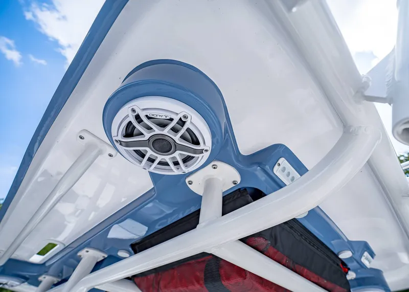 Slide: The Image of 2024 Caymas 26 HB boat speaker system under blue canopy, clear sky background. - 22