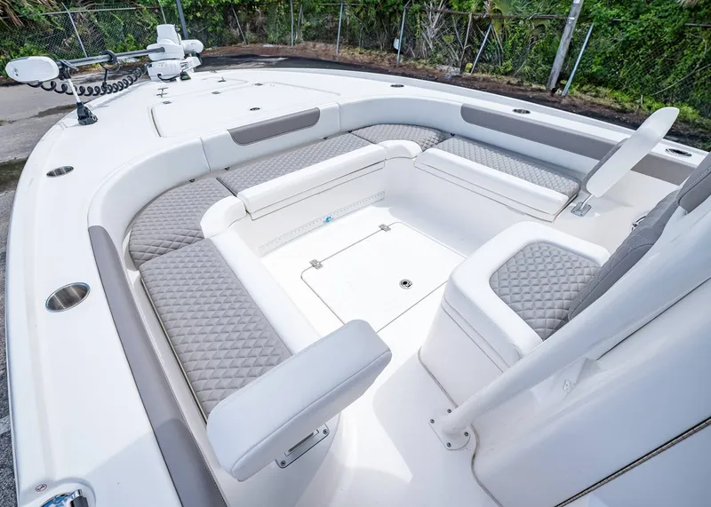 Slide: The Image of 2024 Caymas 26 HB boat interior with cushioned seating and modern design. - 26