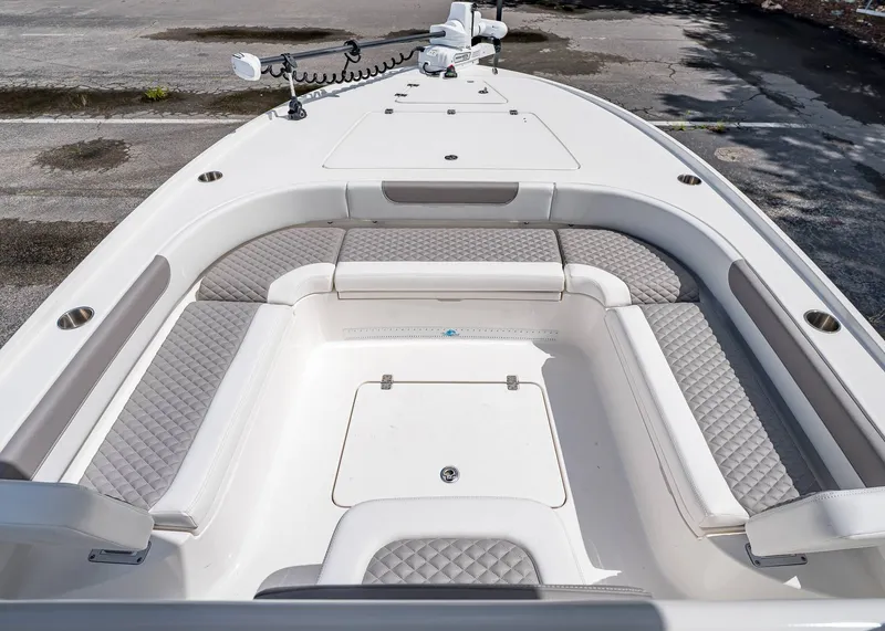 Slide: The Image of 2024 Caymas 26 HB boat interior with cushioned seating and storage compartments. - 27