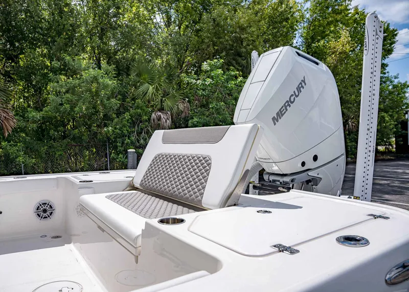 Slide: The Image of 2024 Caymas 26 HB boat with Mercury engine, featuring cushioned seating and sleek design. - 8