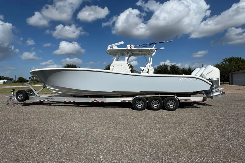 The Image of 2020 Yellowfin 36 Offshore boat with Seakeeper, under a bridge on a cloudy day. - 0