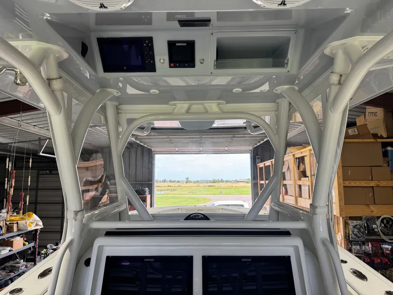 Slide: The Image of 2020 Yellowfin 36 Offshore boat with triple outboard engines on calm water. - 11