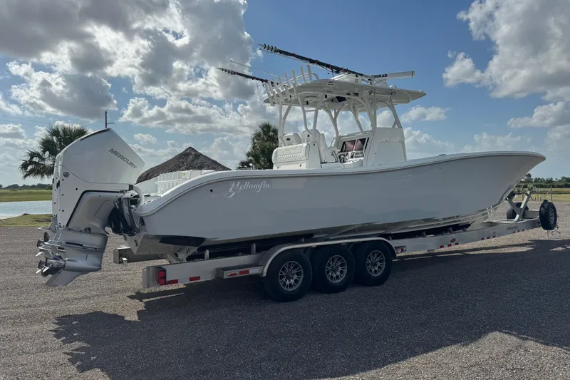 Slide: The Image of 2020 Yellowfin 36 Offshore boat cruising under a bridge on a foggy day. - 2