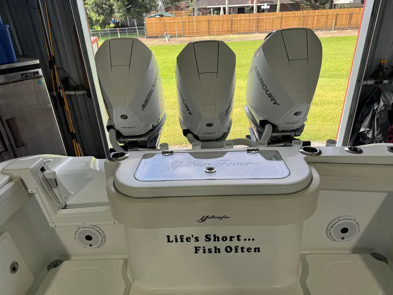 Slide: The Image of 2020 Yellowfin 36 Offshore boat in a garage, featuring rod holders and navigation equipment. - 26