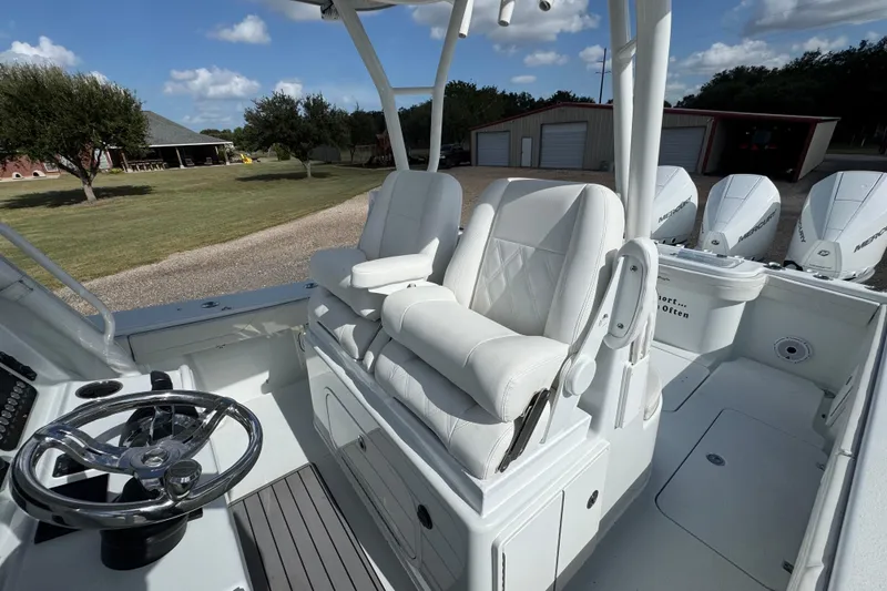 Slide: The Image of 2020 Yellowfin 36 Offshore boat dashboard with dual Simrad displays and control panel. - 27