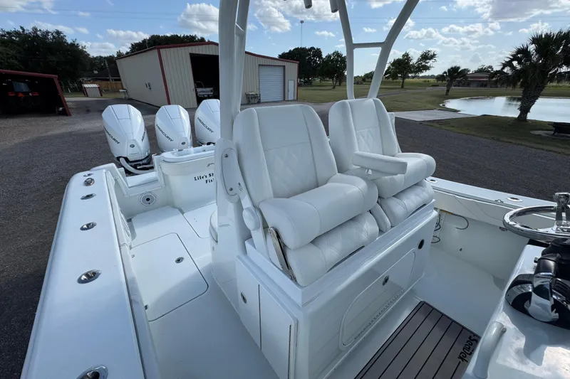 Slide: The Image of 2020 Yellowfin 36 Offshore boat cockpit with steering wheel and navigation screens. - 28