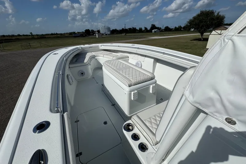 Slide: The Image of 2020 Yellowfin 36 Offshore boat interior with compass, docked on grassy area. - 30