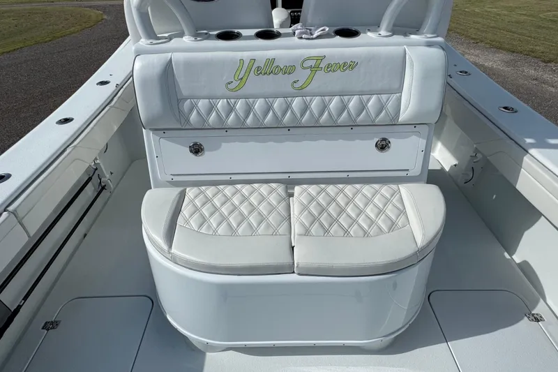 Slide: The Image of 2020 Yellowfin 36 Offshore boat interior with "Yellow Fever" seating in a garage setting. - 39