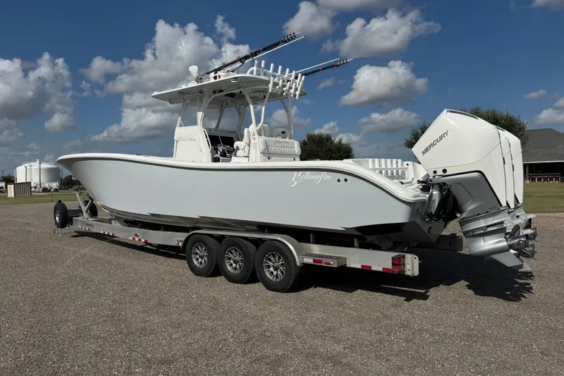 Slide: The Image of 2020 Yellowfin 36 Offshore boat on water near a bridge, overcast sky. - 4