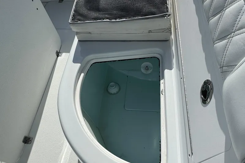 Slide: The Image of 2020 Yellowfin 36 Offshore boat interior with white seating and steering wheel, parked outdoors. - 41