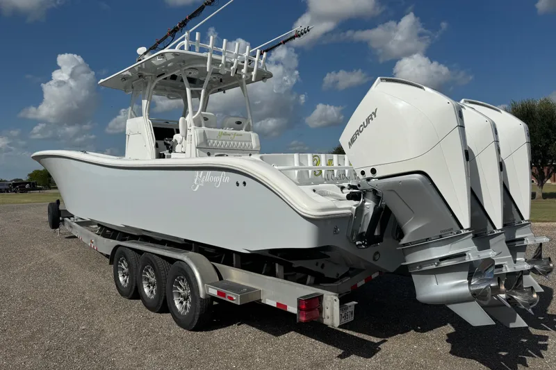Slide: The Image of 2020 Yellowfin 36 Offshore boat cruising near a bridge on a cloudy day. - 5