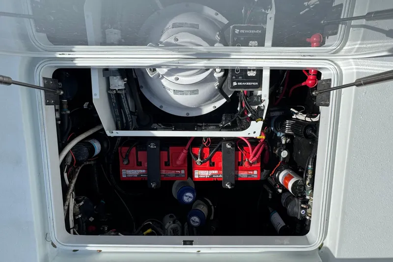 Slide: The Image of Engine compartment of a 2020 Yellowfin 36 Offshore boat, featuring batteries and Seakeeper system. - 68