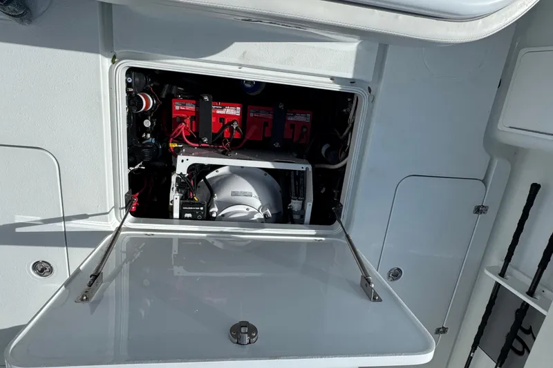 Slide: The Image of 2020 Yellowfin 36 Offshore boat battery compartment with red batteries and wiring. - 69