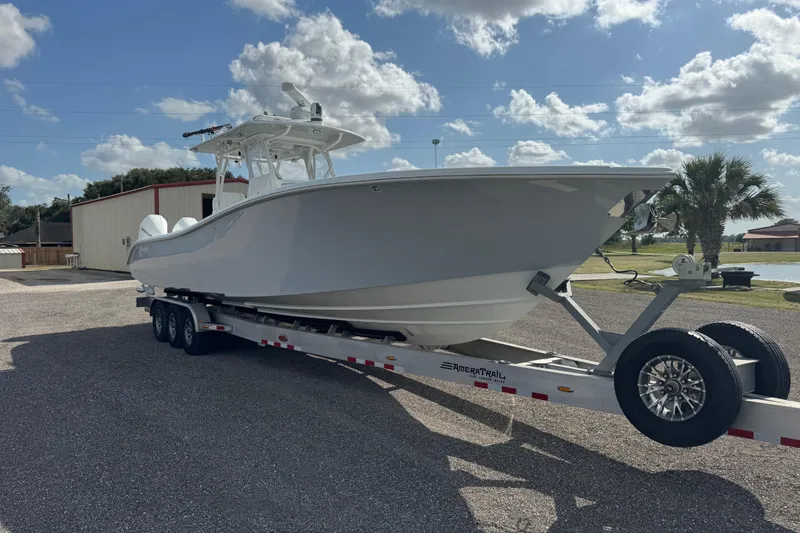 Slide: The Image of 2020 Yellowfin 36 Offshore boat on water with bridge in background. - 7