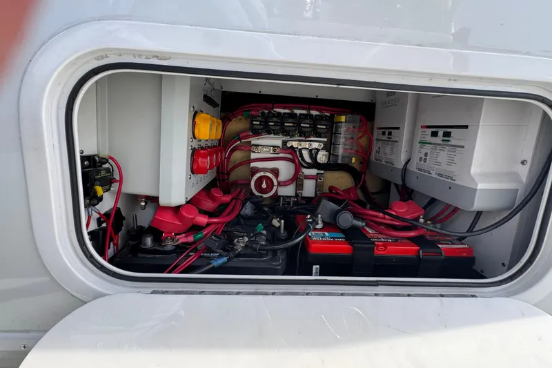 Slide: The Image of Electrical compartment of a 2020 Yellowfin 36 Offshore boat, featuring batteries and wiring. - 71