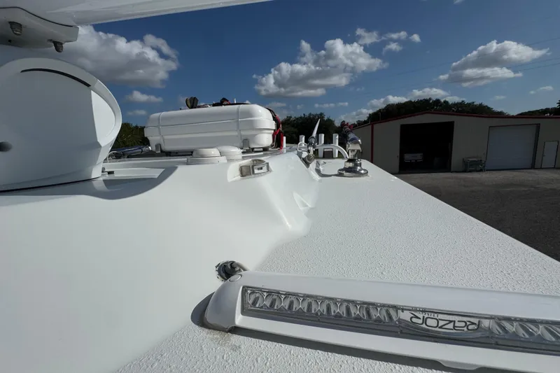 Slide: The Image of 2020 Yellowfin 36 Offshore boat deck with equipment under a clear blue sky. - 73