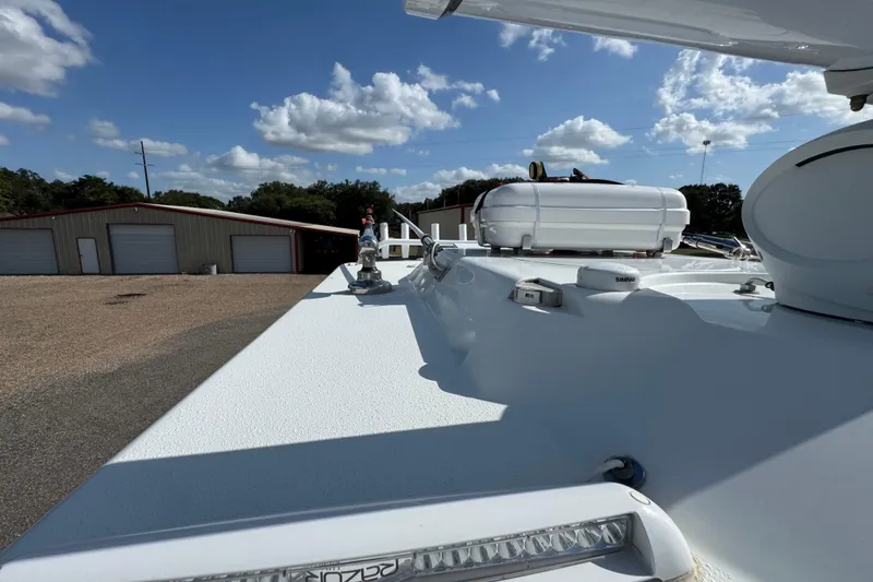 Slide: The Image of 2020 Yellowfin 36 Offshore boat deck with clear sky and storage buildings. - 74