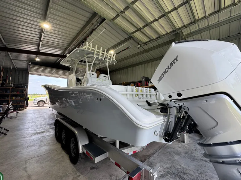 Slide: The Image of 2020 Yellowfin 36 Offshore boat on calm water with bridge in background. - 9