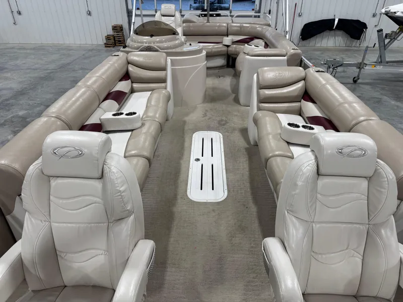 Slide: The Image of Luxurious 2008 Crest III 2570 pontoon boat interior with plush seating and cup holders. - 11