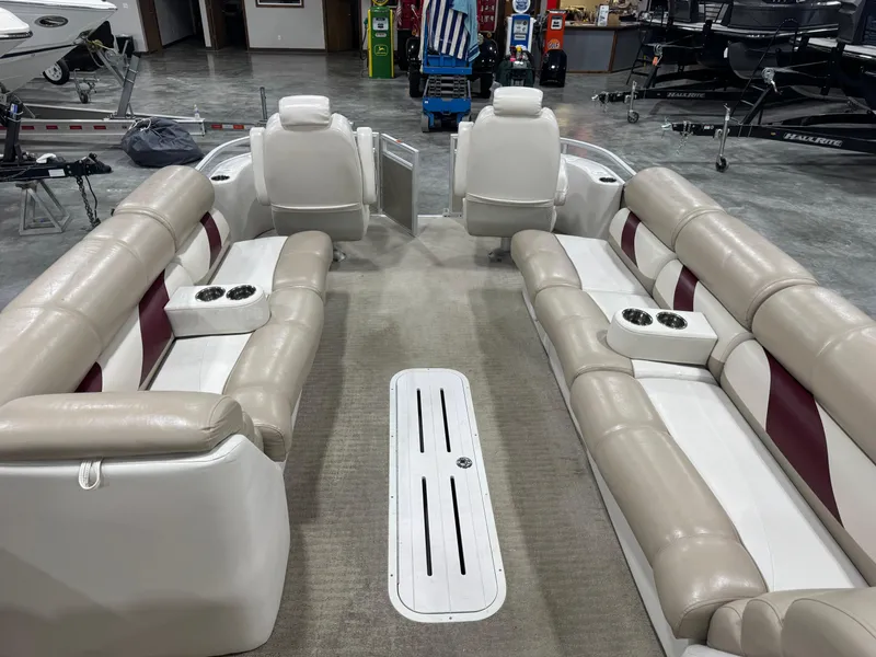 Slide: The Image of 2008 Crest III 2570 pontoon boat interior with beige seating and cup holders. - 12