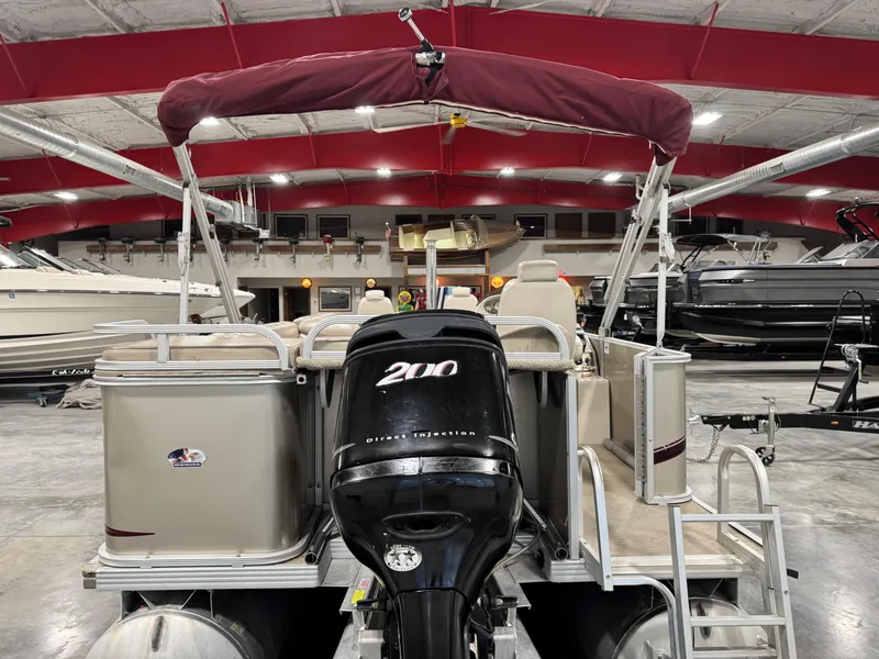 Slide: The Image of 2008 Crest III 2570 pontoon boat with 200 HP engine in a showroom. - 15