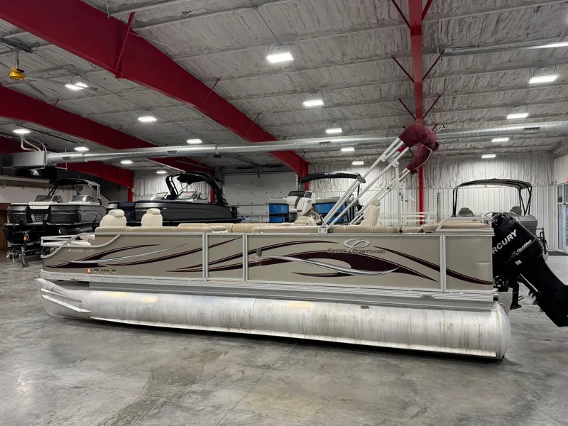 Slide: The Image of 2008 Crest III 2570 pontoon boat in indoor showroom with red beams. - 4