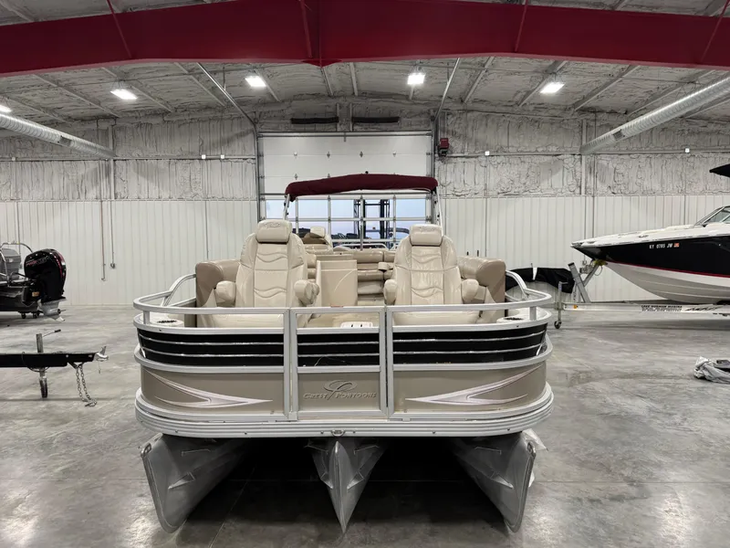 Slide: The Image of 2008 Crest III 2570 pontoon boat in a spacious indoor storage facility. - 5