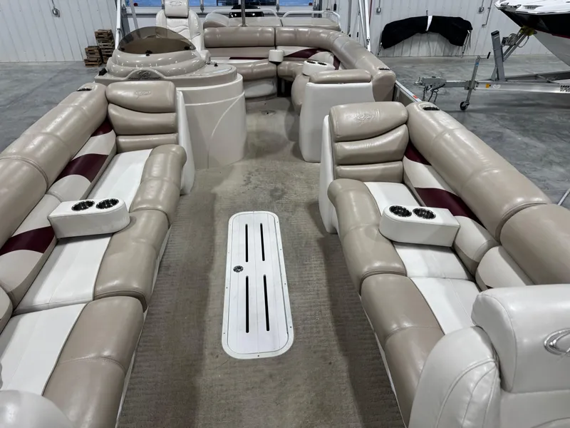 Slide: The Image of Interior of a 2008 Crest III 2570 pontoon boat with beige seating and cup holders. - 8
