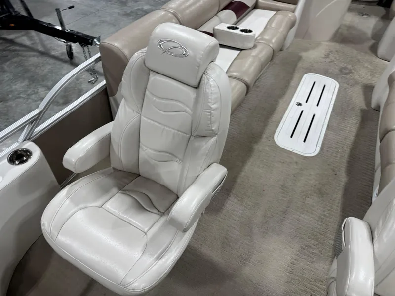 Slide: The Image of 2008 Crest III 2570 boat interior with beige leather seating and cup holders. - 9