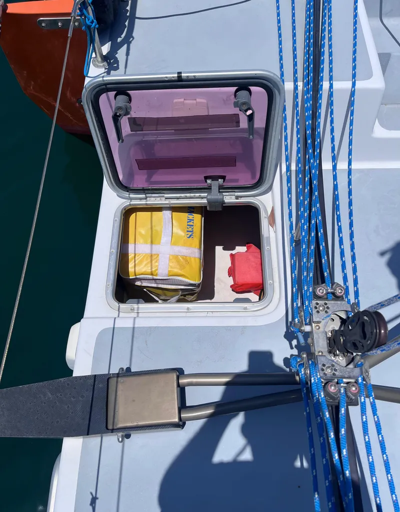 Slide: The Image of Open hatch on Class 40 Antrim Design sailboat, showing storage with safety equipment. - 16