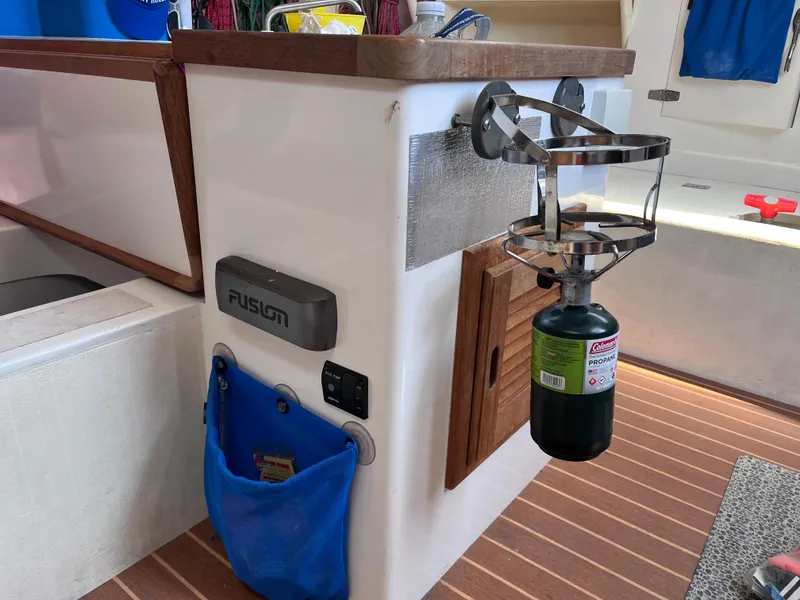 Slide: The Image of Interior of 2009 Class 40 Antrim Design boat with propane tank holder and Fusion audio system. - 26