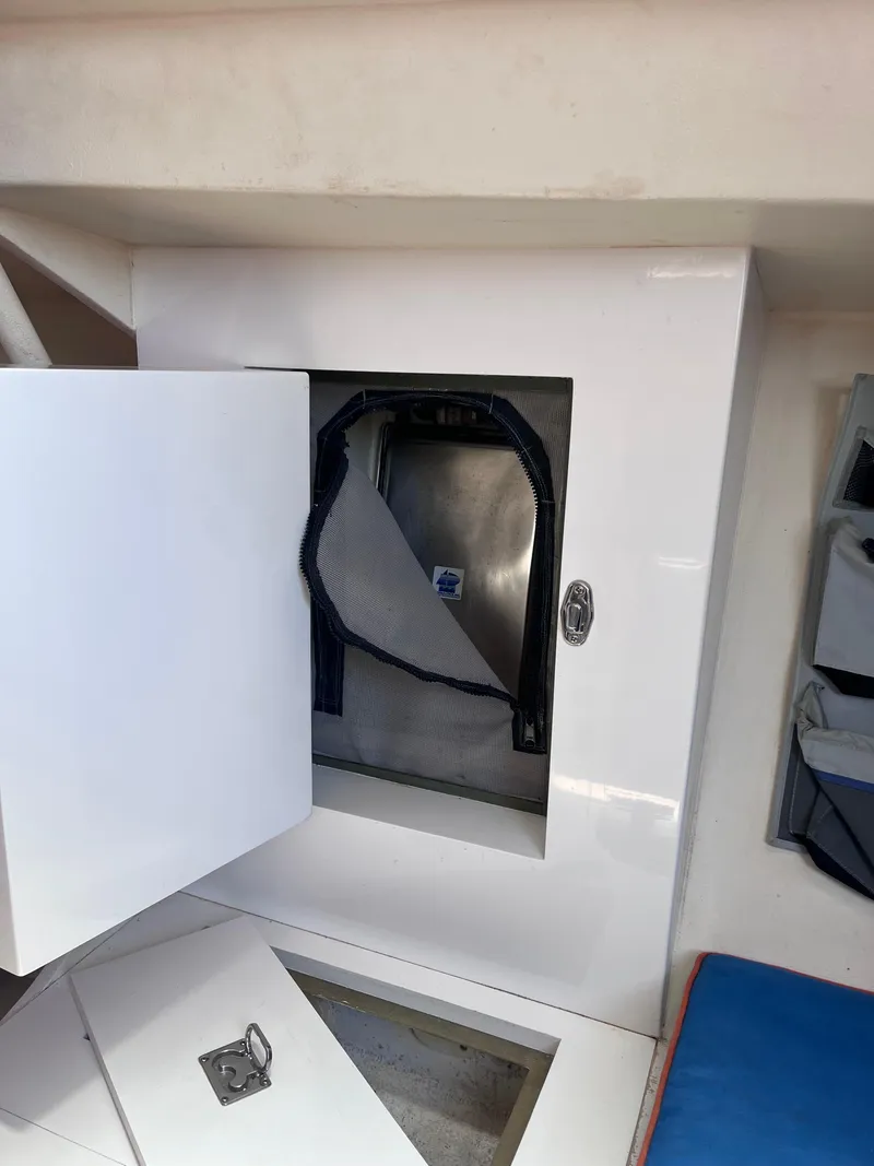 Slide: The Image of Open storage compartment in 2009 Class 40 Antrim Design boat interior. - 27