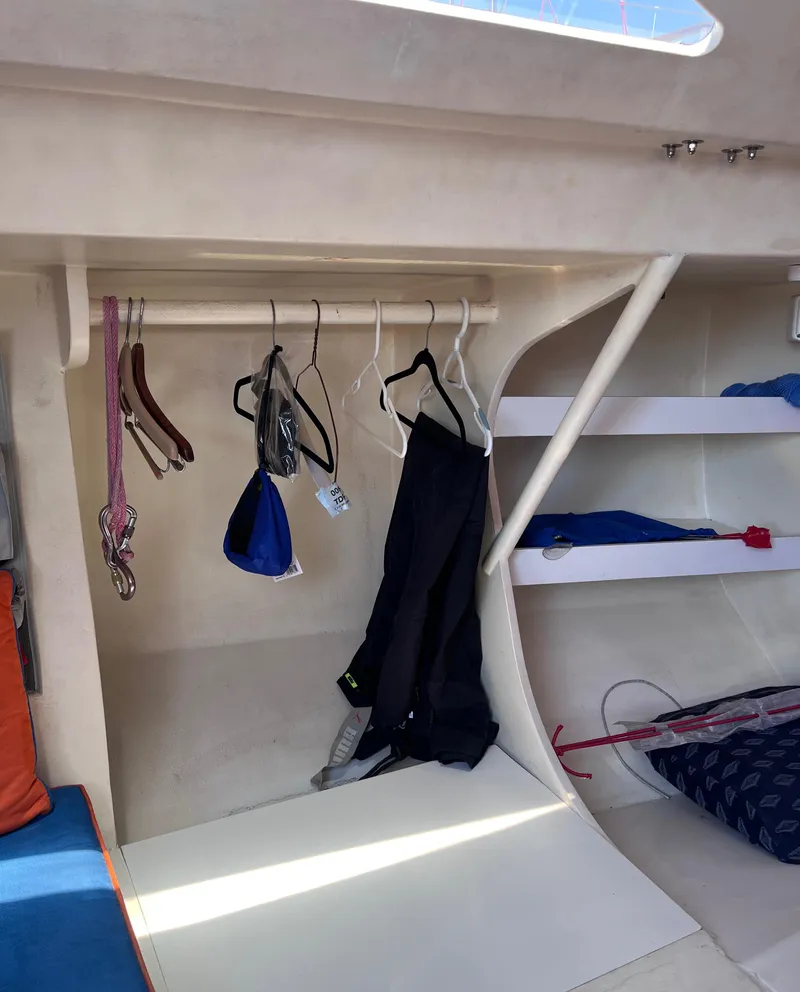 Slide: The Image of Interior of 2009 Class 40 Antrim Design sailboat with hanging clothes and storage shelves. - 30