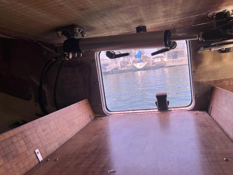 Slide: The Image of Interior view of a 2009 Class 40 Antrim Design boat, showing a window and wooden surfaces. - 34