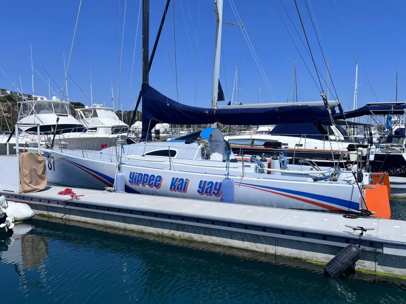 Slide: The Image of Class 40 Antrim Design sailboat docked, 2009 model, with "yippee kai yay" text on hull. - 4