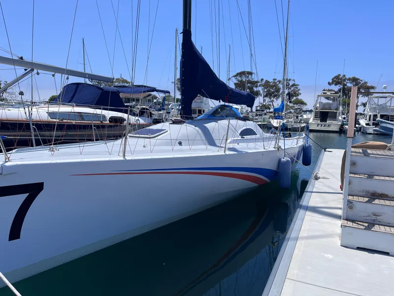 Slide: The Image of Sleek 2009 Class 40 Antrim Design sailboat docked at marina under clear blue sky. - 5