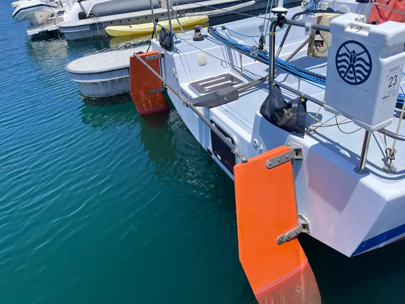 Slide: The Image of Sailboat with orange rudders docked in marina, Class 40 Antrim Design, 2009 model. - 6