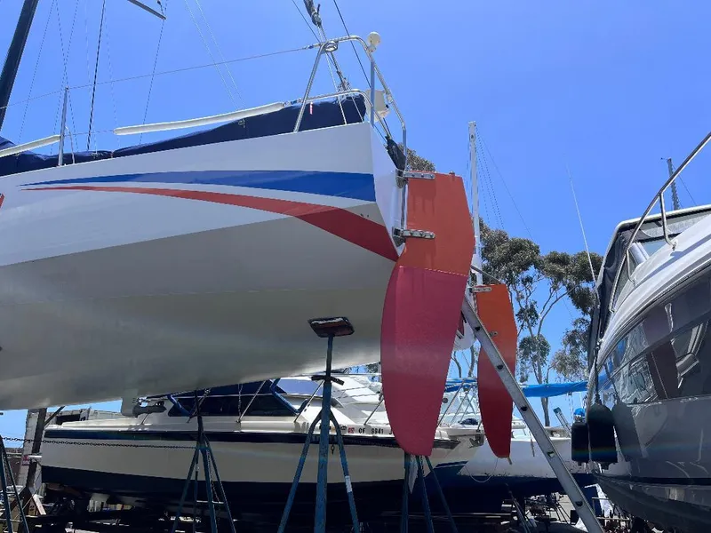 Slide: The Image of Sailboat on stands, Class 40 Antrim Design, 2009, with vibrant red and blue accents. - 7