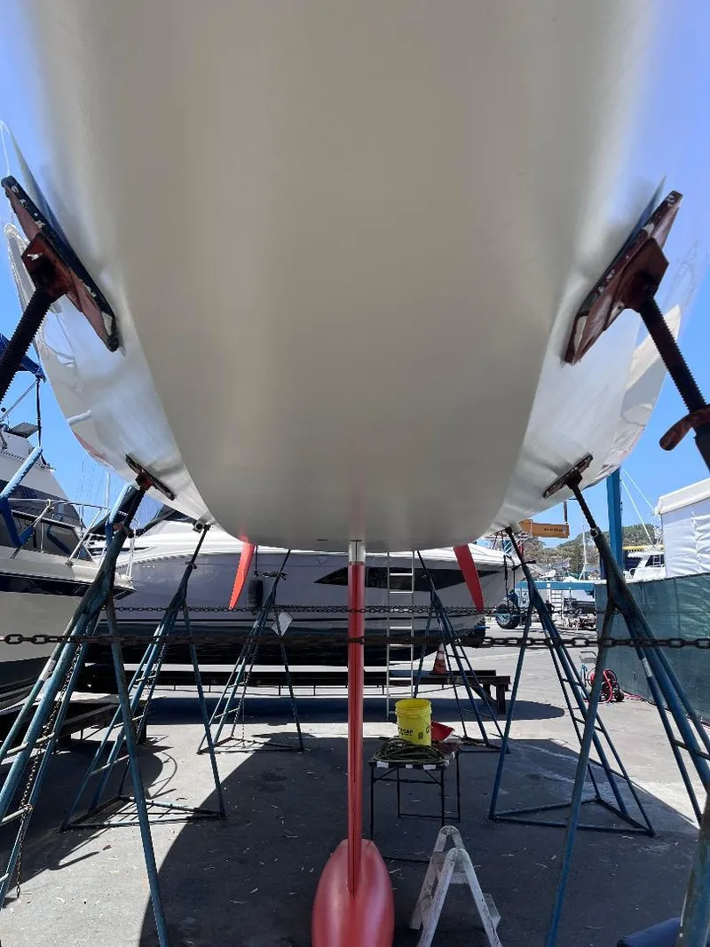Slide: The Image of Underneath view of a 2009 Class 40 Antrim Design sailboat on stands in a boatyard. - 8