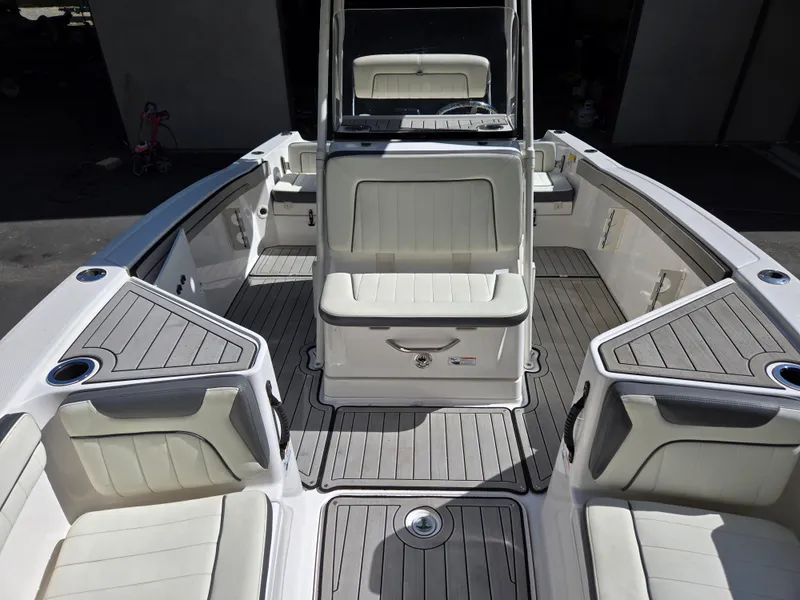 Slide: The Image of 2022 Yamaha Boats 210 FSH Deluxe interior with seating and storage compartments. - 10