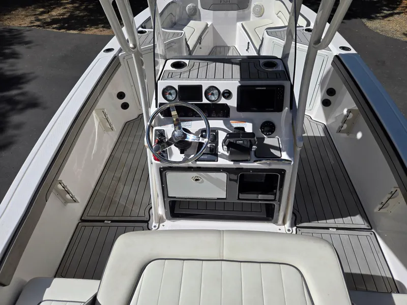 Slide: The Image of 2022 Yamaha Boats 210 FSH Deluxe cockpit with steering wheel and controls. - 13