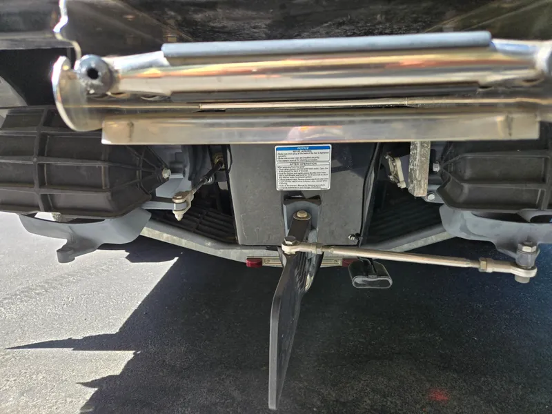 Slide: The Image of Rear view of 2022 Yamaha Boats 210 FSH Deluxe, showcasing engine components and steering mechanism. - 15